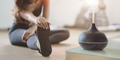 Woman-exercising-with-oil-diffuser-in-the-room